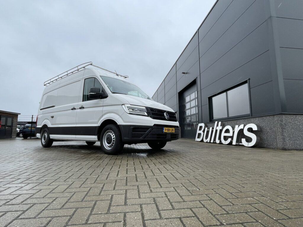 Moderne bedrijfswagen met op maat gemaakte inrichting voor efficiënt transport en logistiek, geparkeerd voor een bedrijfspand met Bulters-logo.